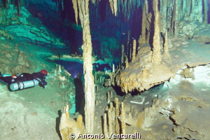 divers lighting the beauty of the Dreamgate cave, Riviera... by Antonio Venturelli 